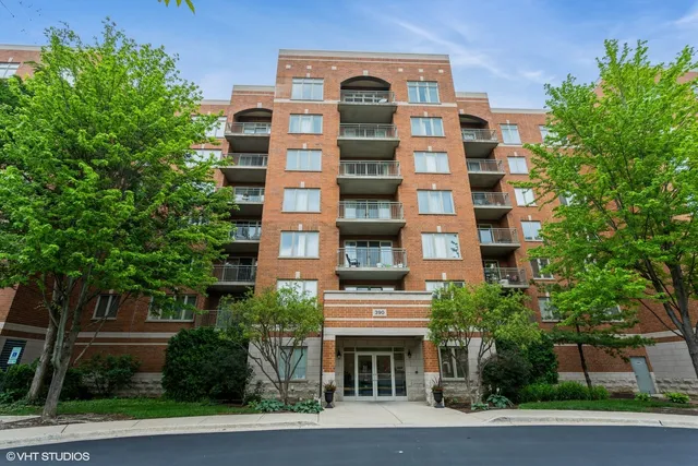 a front view of a multi story building with a yard
