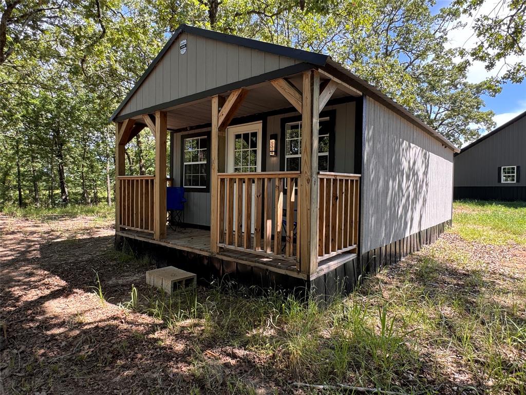 1411 Rains County Road 2610 Alba, TX 75410 - Photo 11 of 25 a view of a small house with wooden fence in front of it