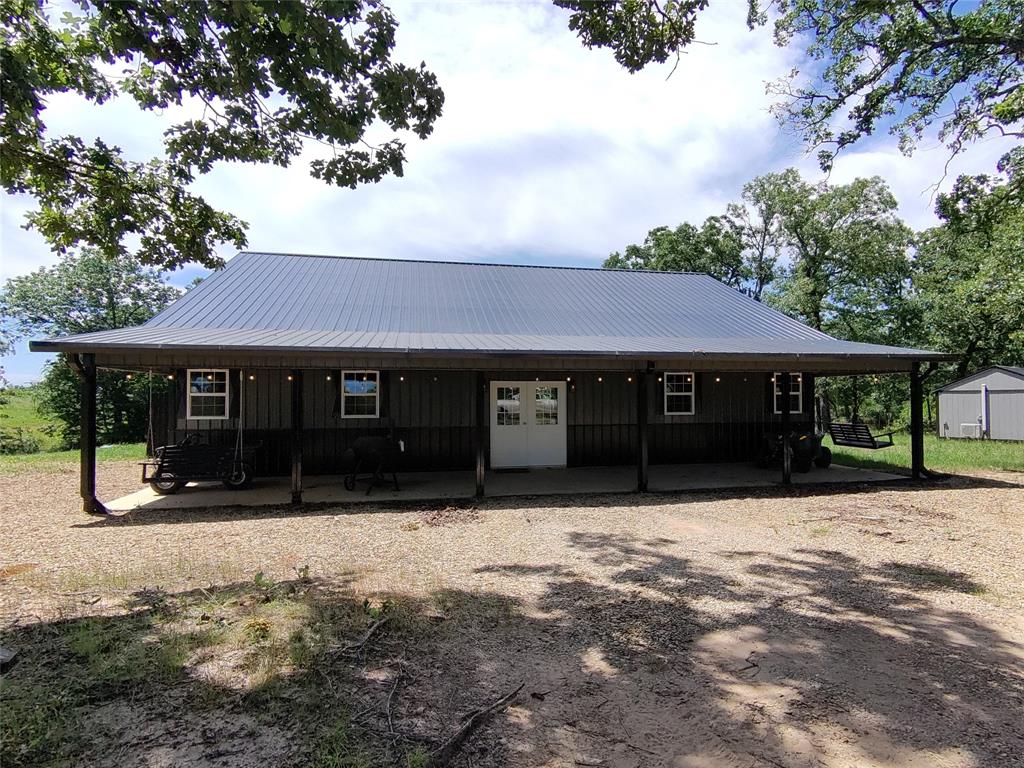 1411 Rains County Road 2610 Alba, TX 75410 - Photo 2 of 25 a front view of a house with a yard covered in snow