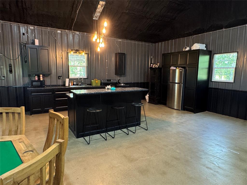 1411 Rains County Road 2610 Alba, TX 75410 - Photo 7 of 25 a kitchen with stainless steel appliances kitchen island granite countertop a refrigerator and a stove