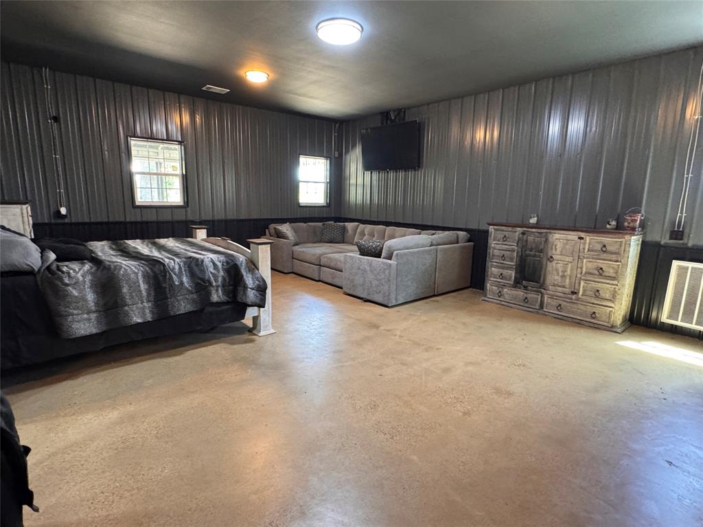 1411 Rains County Road 2610 Alba, TX 75410 - Photo 9 of 25 a spacious bedroom with a bed and a night stand