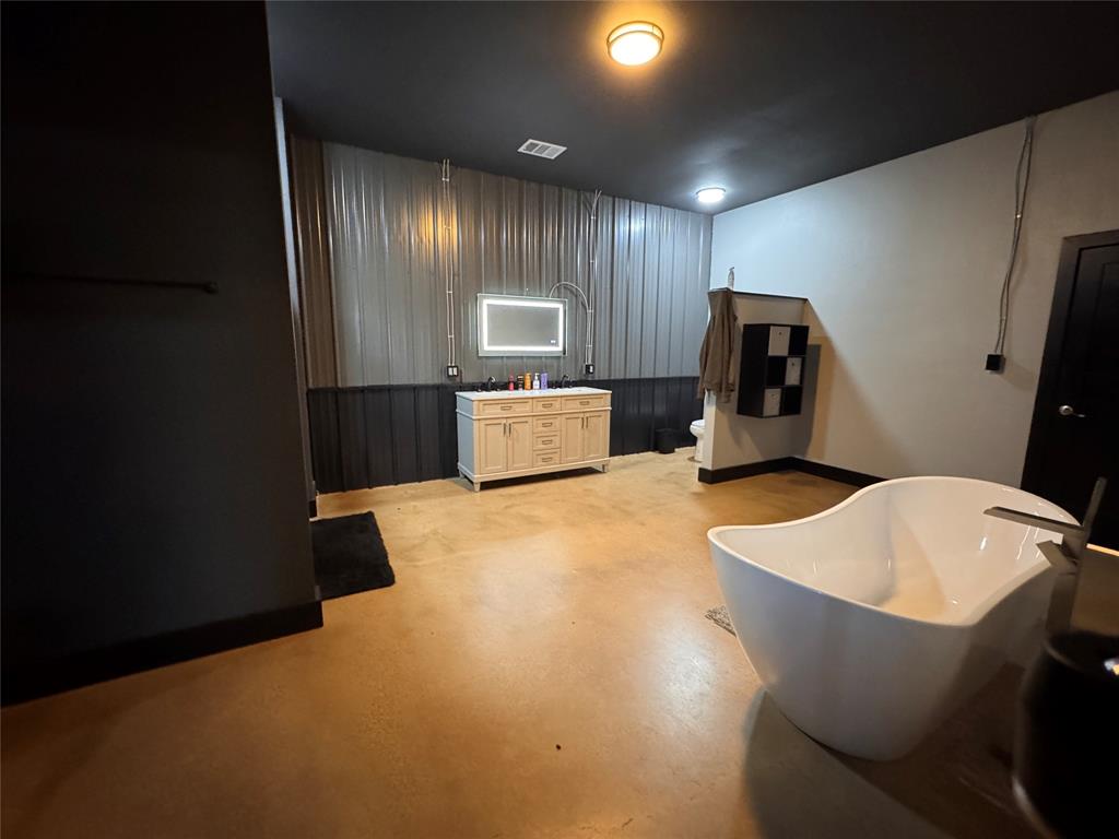 1411 Rains County Road 2610 Alba, TX 75410 - Photo 10 of 25 a large room with kitchen island a sink wooden floor and a refrigerator