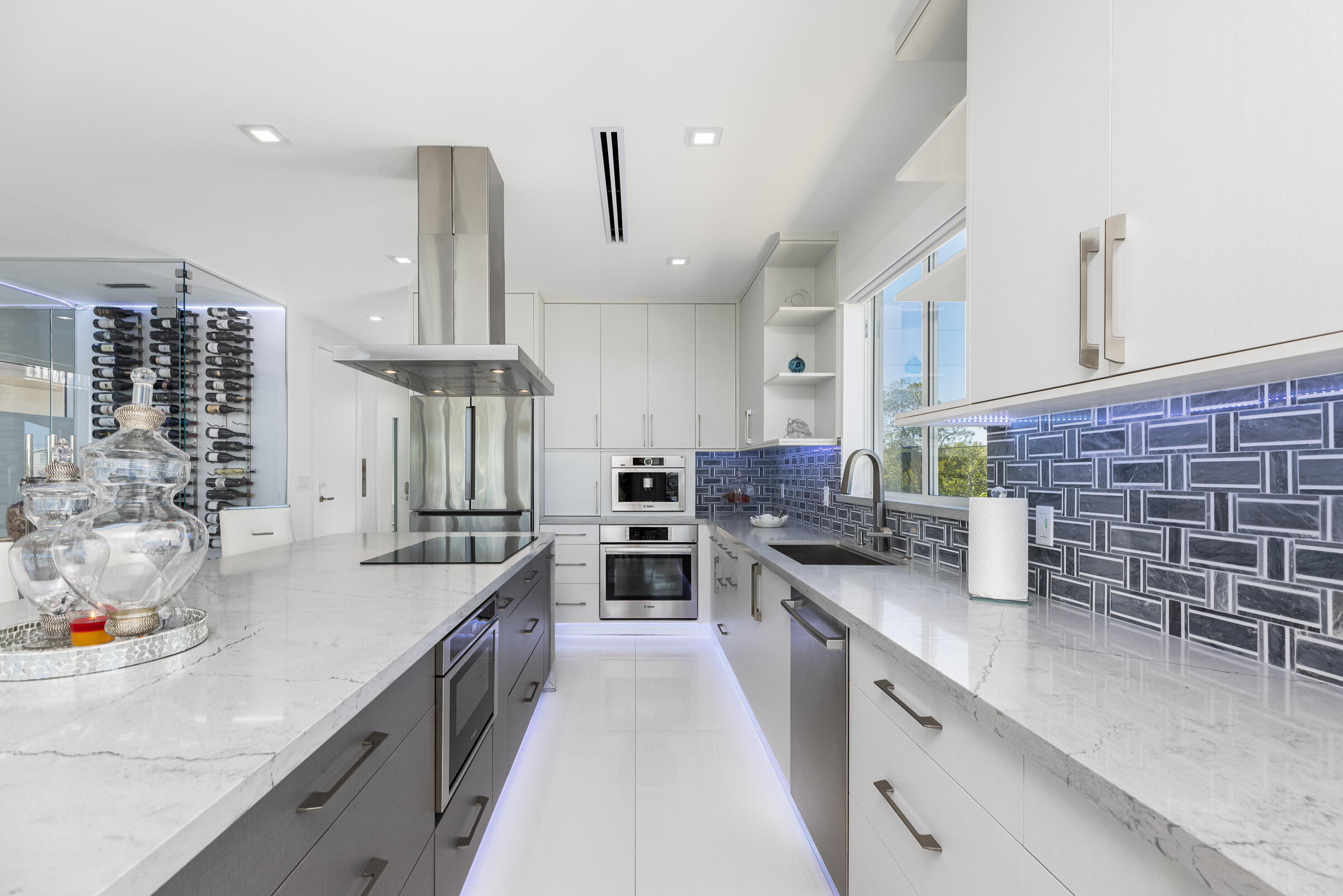45 Cormorant Drive Key Largo, FL 33037 - Photo 11 of 51 a kitchen with stainless steel appliances a sink a stove and a wooden floors