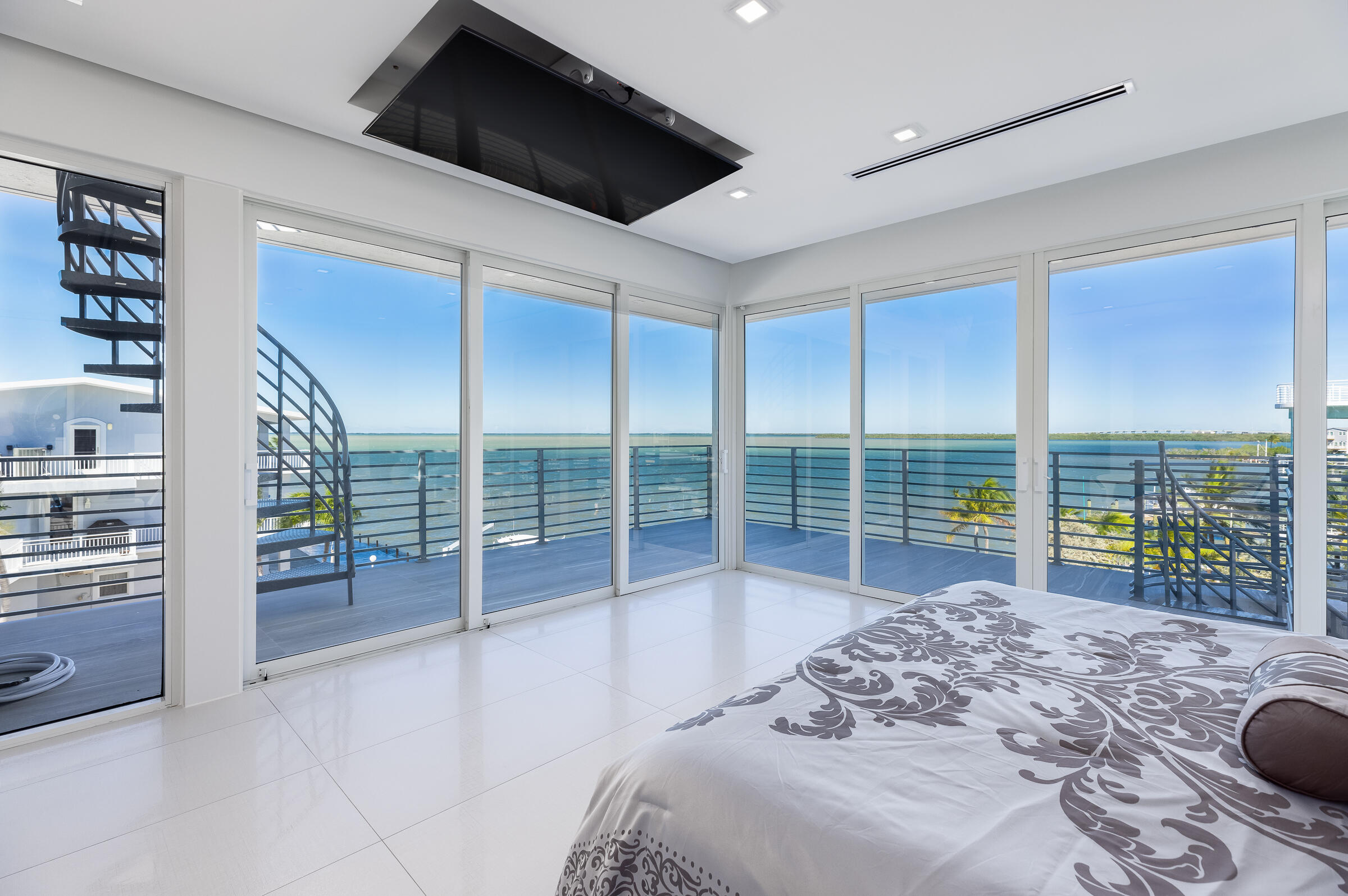 45 Cormorant Drive Key Largo, FL 33037 - Photo 17 of 51 a bedroom with furniture and large windows