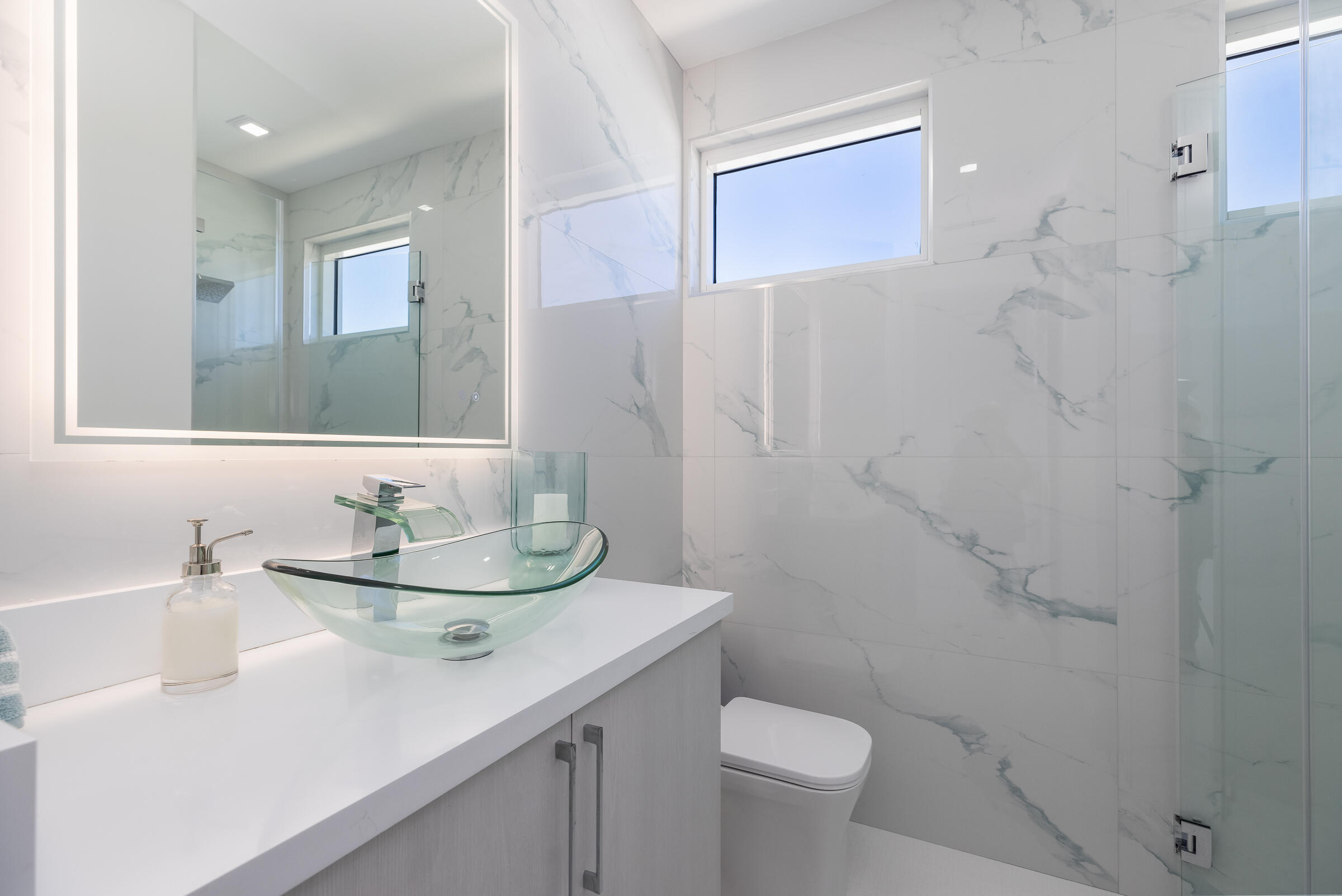 45 Cormorant Drive Key Largo, FL 33037 - Photo 33 of 51 a bathroom with a sink a toilet a mirror and shower