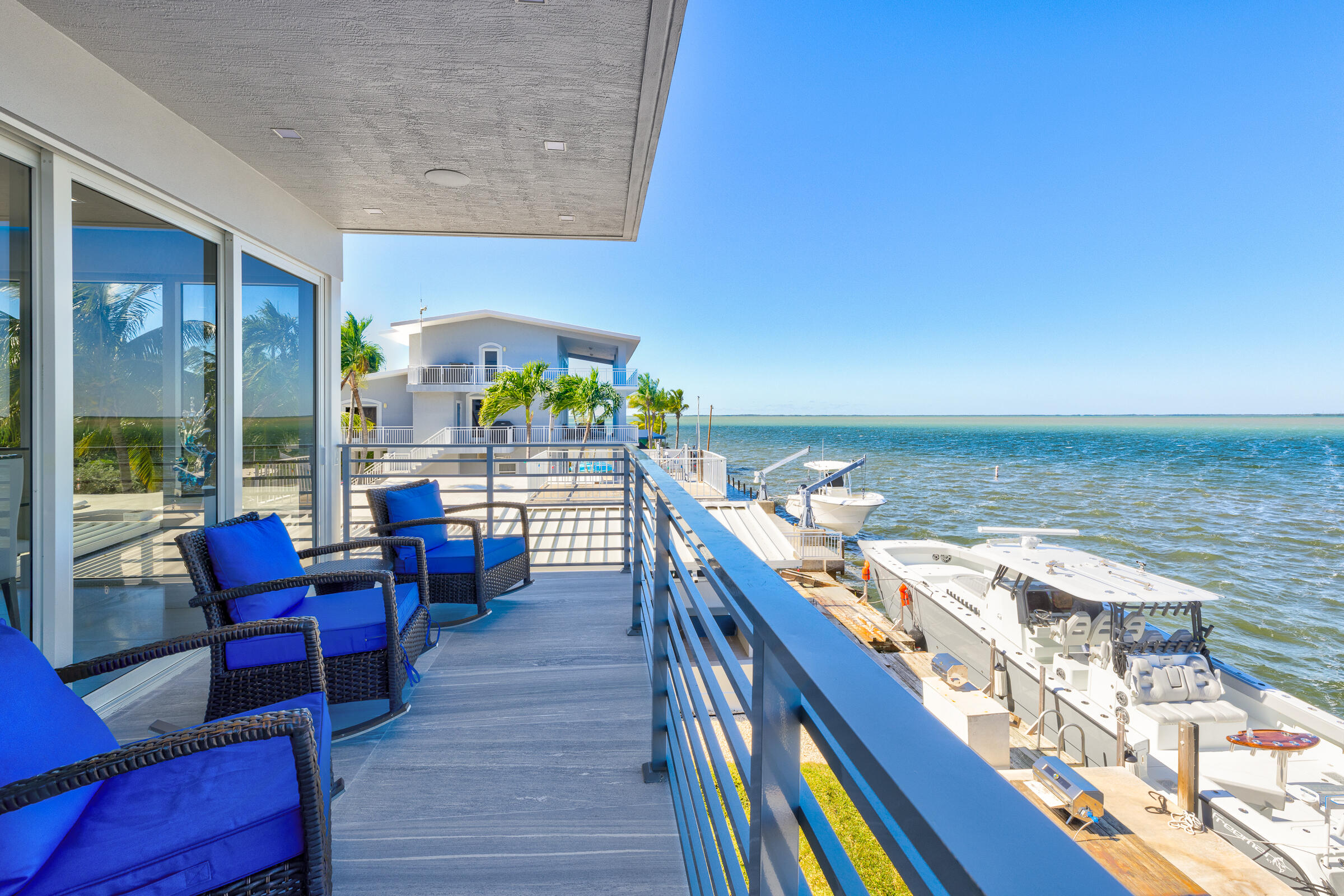 45 Cormorant Drive Key Largo, FL 33037 - Photo 34 of 51 a view of a balcony with chairs and wooden floor