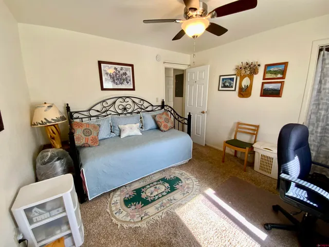 a bedroom with furniture and wooden floor