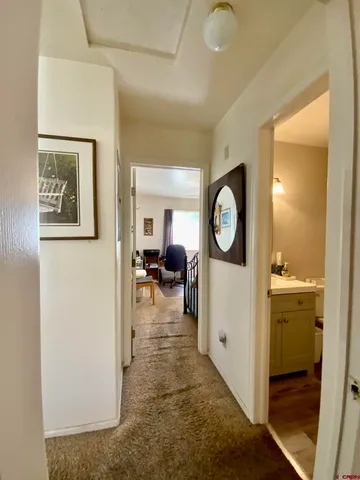 a living room with furniture a mirror and a table