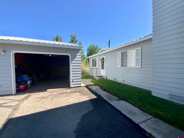 a view of a house with a small yard and a large window