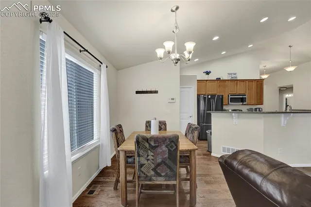 a view of a dining room with furniture and chandelier