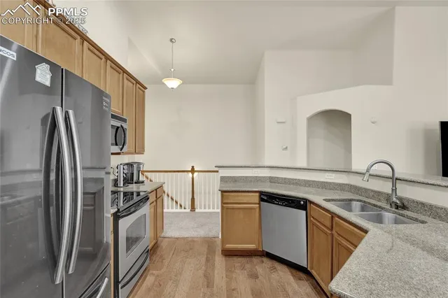 a kitchen with a sink stove and refrigerator