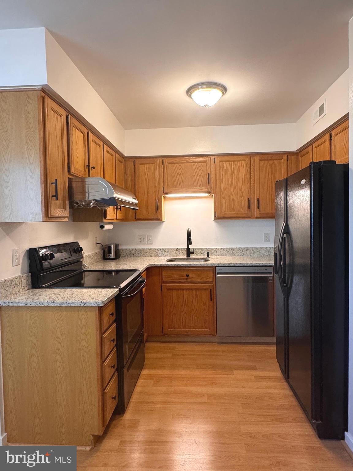 363 Chickory Way Newark, DE 19711 - Photo 13 of 42 a large kitchen with stainless steel appliances granite countertop a stove a sink dishwasher and a refrigerator