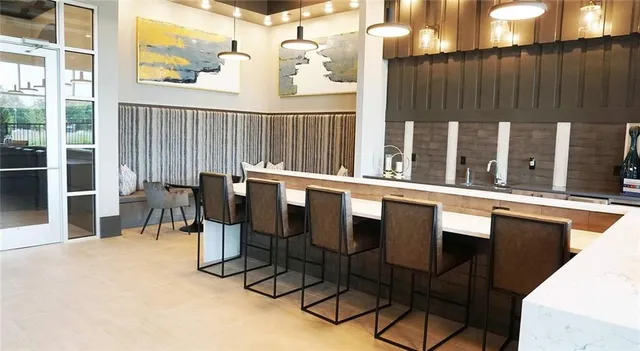 a view of a chairs and table in the balcony