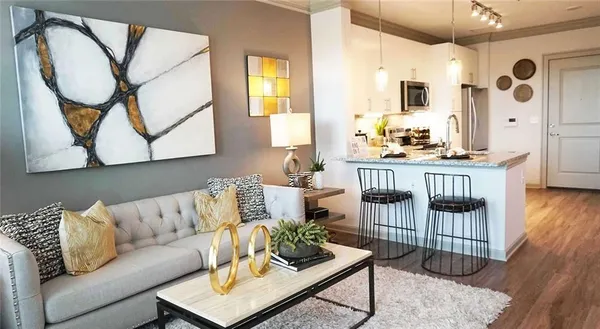 a living room with furniture a flat screen tv and a large window