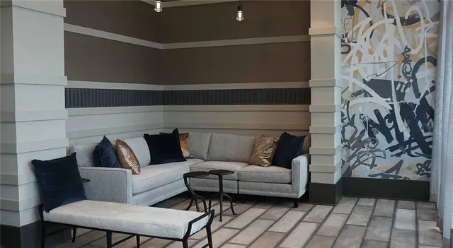 a living room with furniture and a potted plant