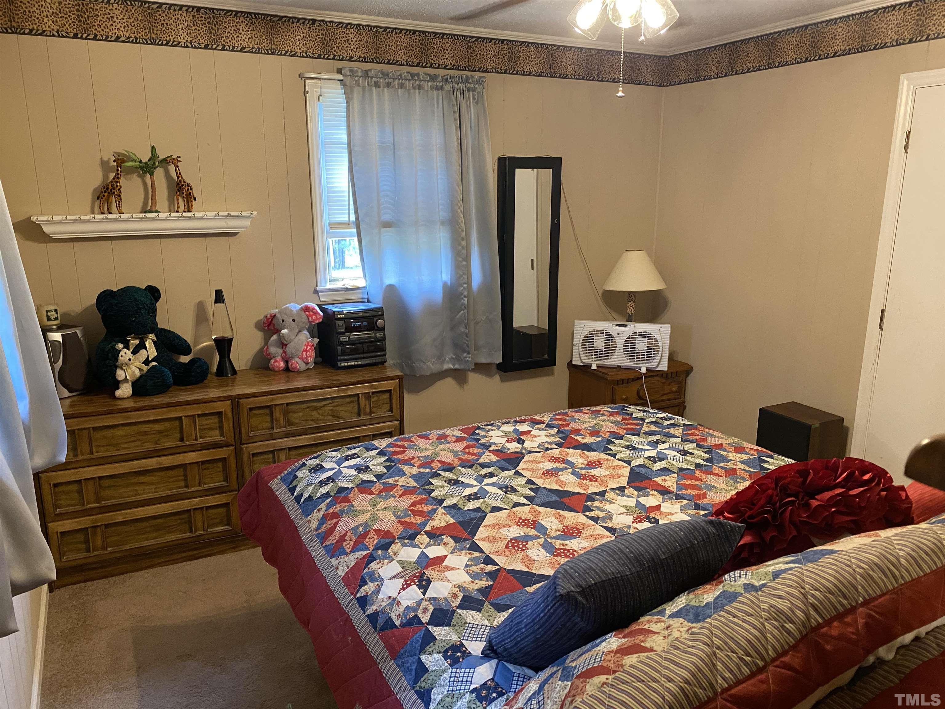 2520 Ardsley Drive Durham, NC 27704 - Photo 10 of 28 a bedroom with a bed and a dresser in it