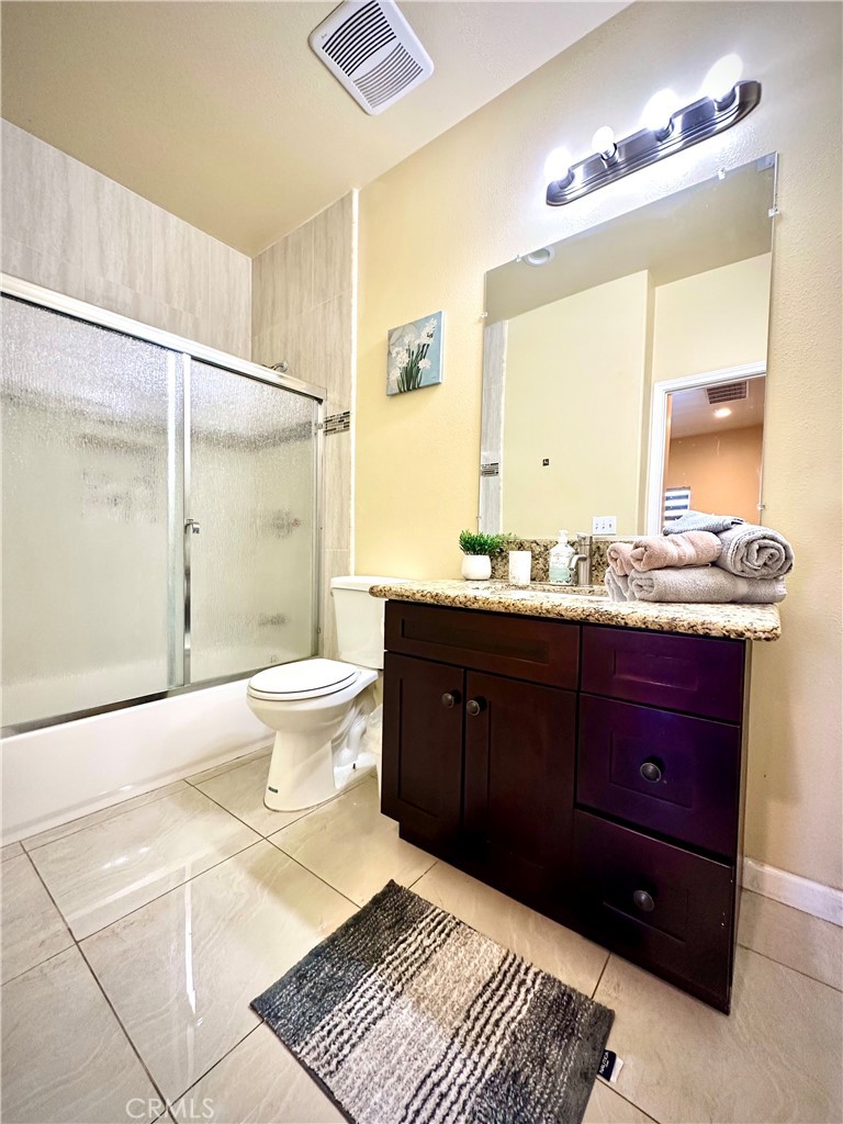 228 North Orange Avenue Rialto, CA 92376 - Photo 13 of 34 a bathroom with a sink a toilet and shower