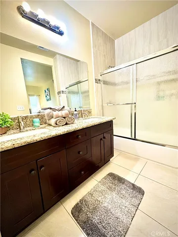 a bathroom with a double vanity sink and a mirror