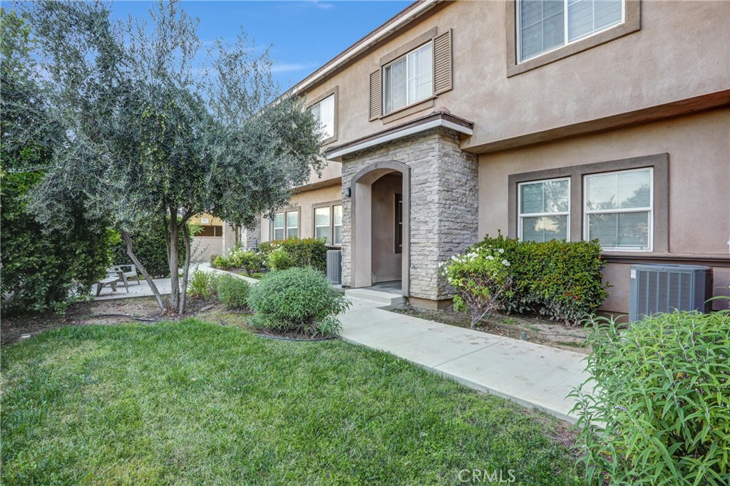 228 North Orange Avenue Rialto, CA 92376 - Photo 22 of 34 a front view of a house with a yard