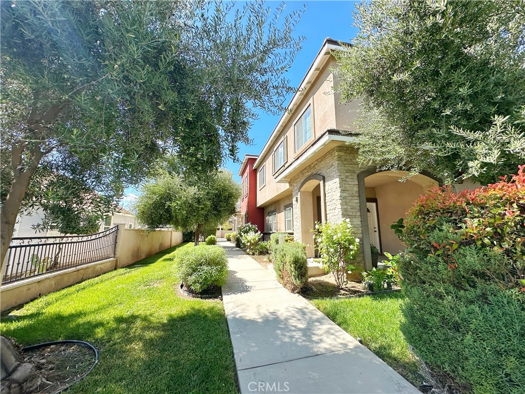228 North Orange Avenue Rialto, CA 92376 - Photo 3 of 34 a view of a house with backyard and a tree