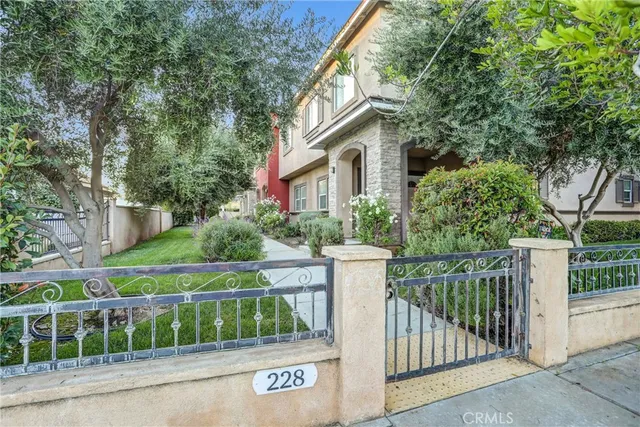 a view of a house with a small yard and plants