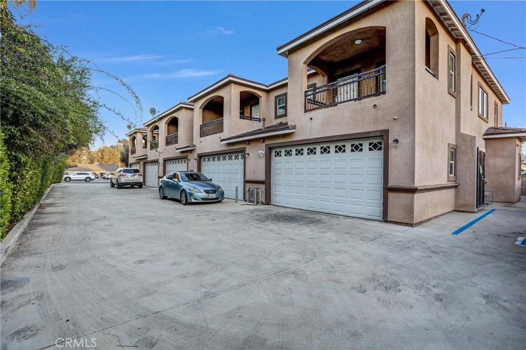 228 North Orange Avenue Rialto, CA 92376 - Photo 8 of 34 a front view of a house with a yard and garage