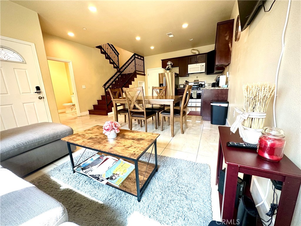 228 North Orange Avenue Rialto, CA 92376 - Photo 9 of 34 a living room with lots of furniture and a painting
