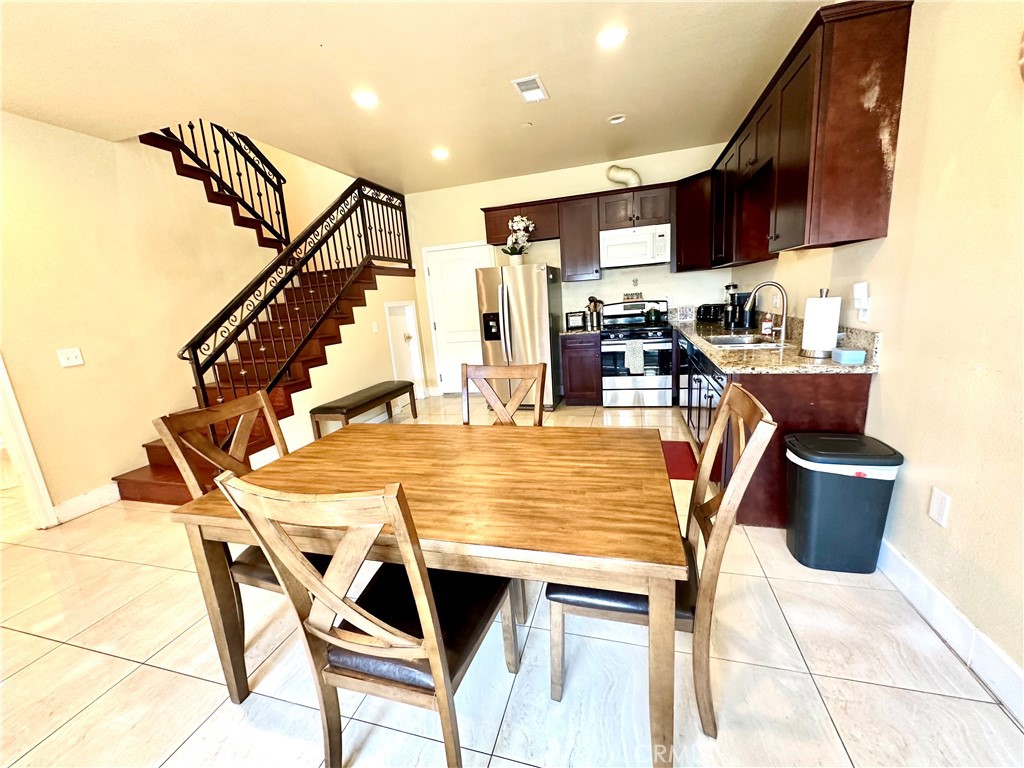 228 North Orange Avenue Rialto, CA 92376 - Photo 10 of 34 a dining table & chairs in a kitchen