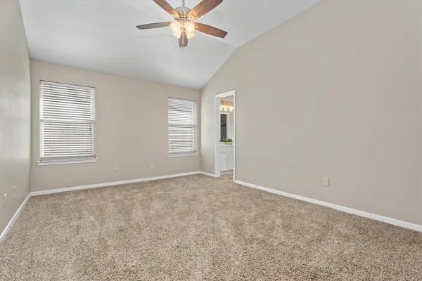 a view of an empty room with window and fireplace
