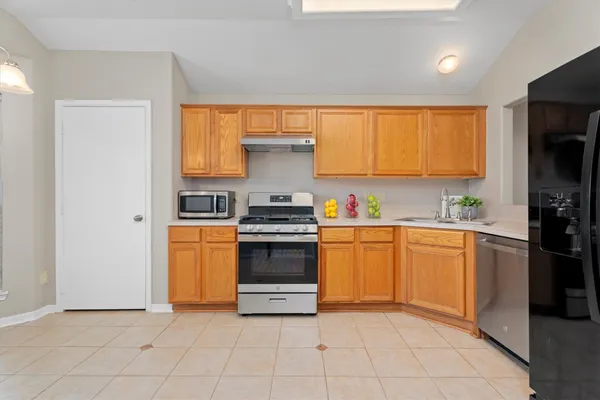 a kitchen with a sink cabinets and stainless steel appliances