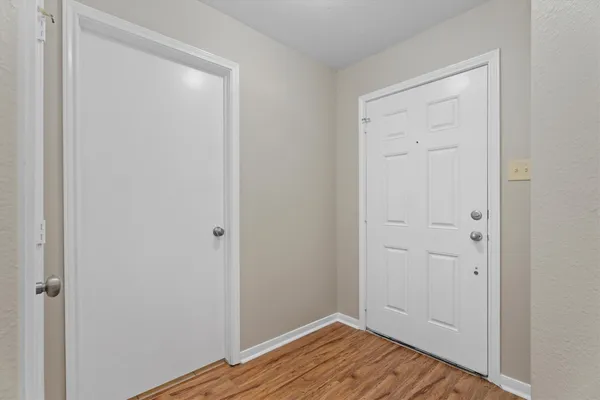 a view of a room with wooden floor and workspace