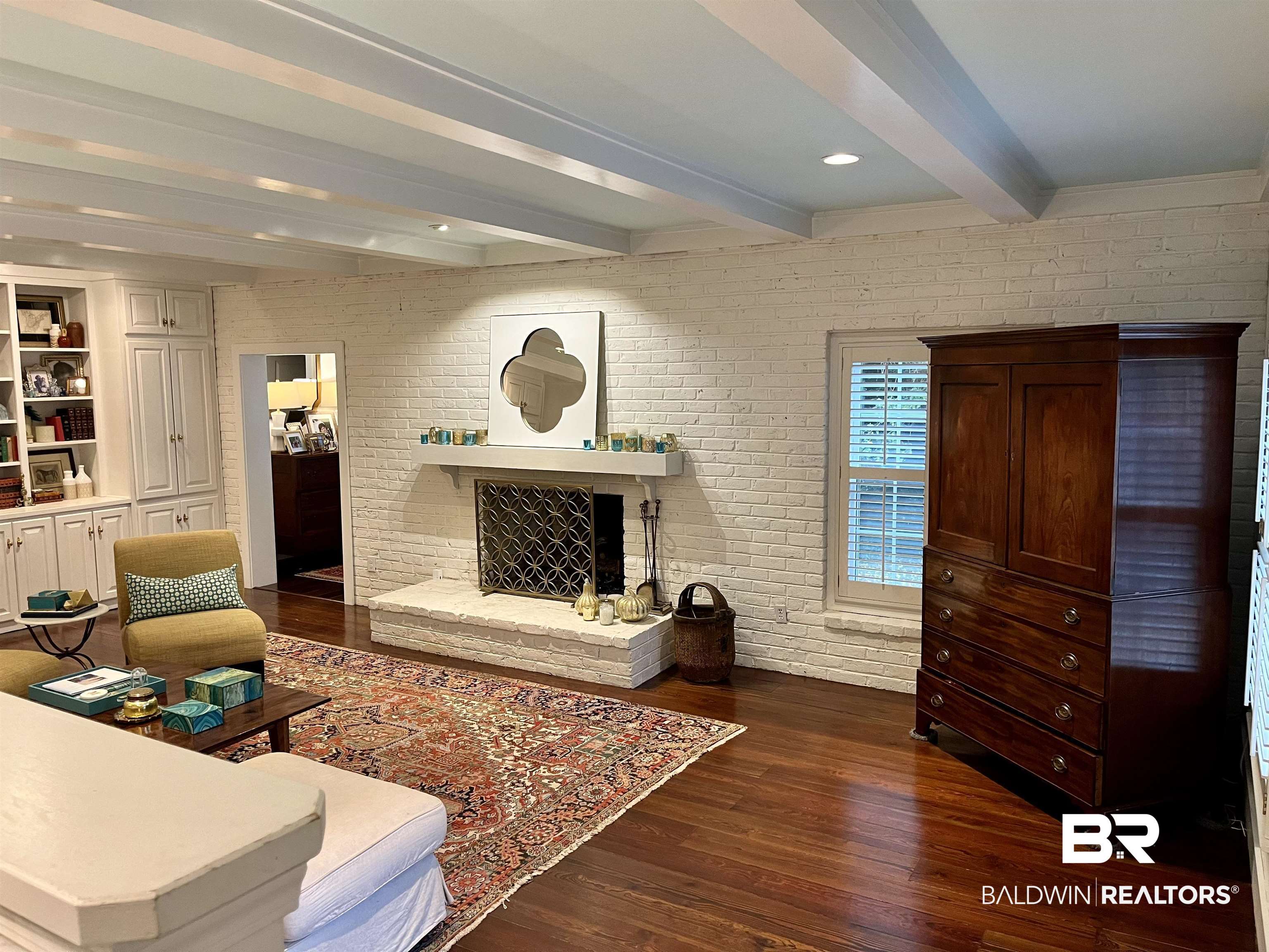 451 Ridgelawn Drive West Mobile, AL 36608 - Photo 18 of 41 Living room featuring beam ceiling, dark wood-type flooring, and brick wall