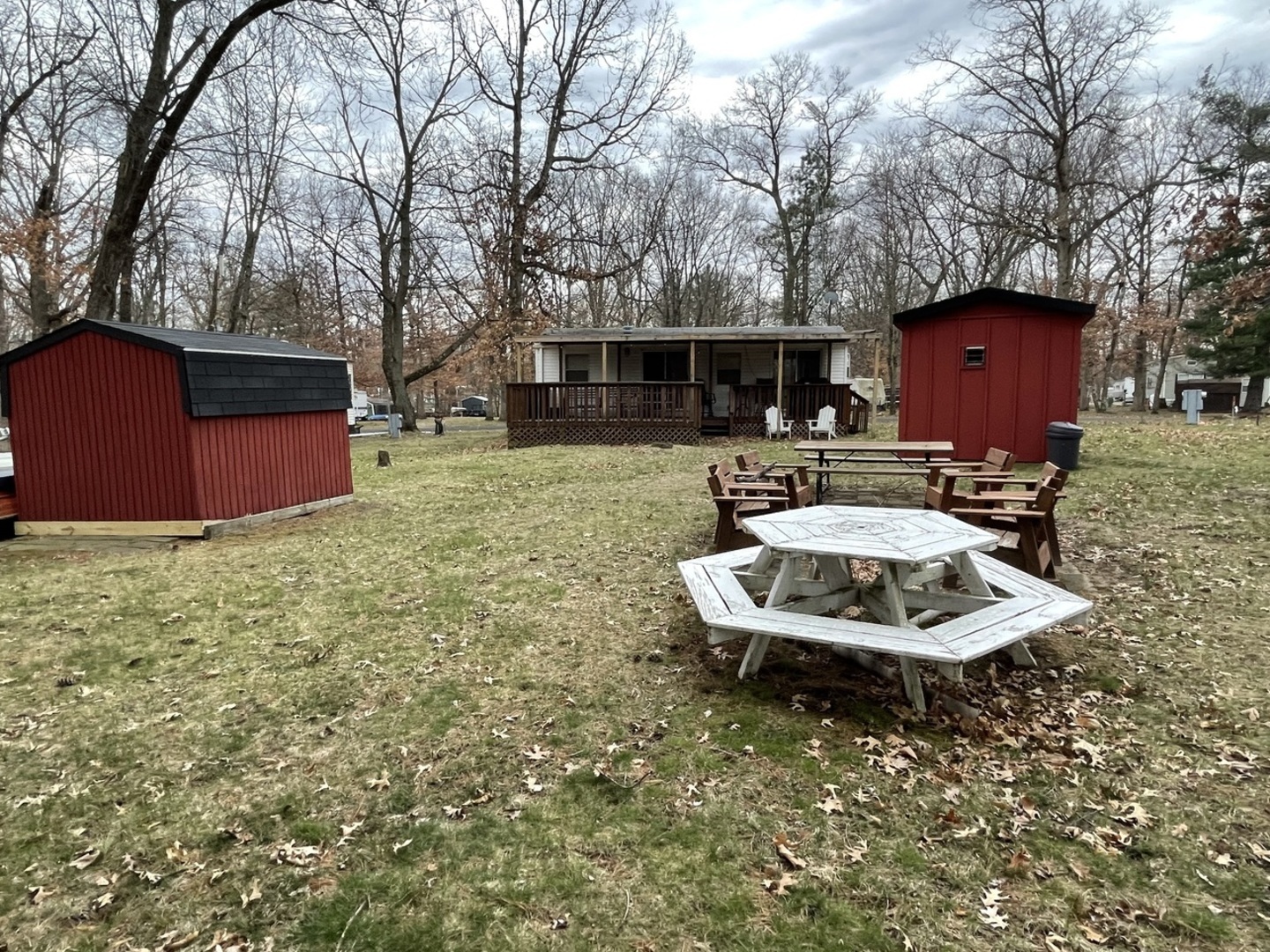a backyard of a house with table and chairs