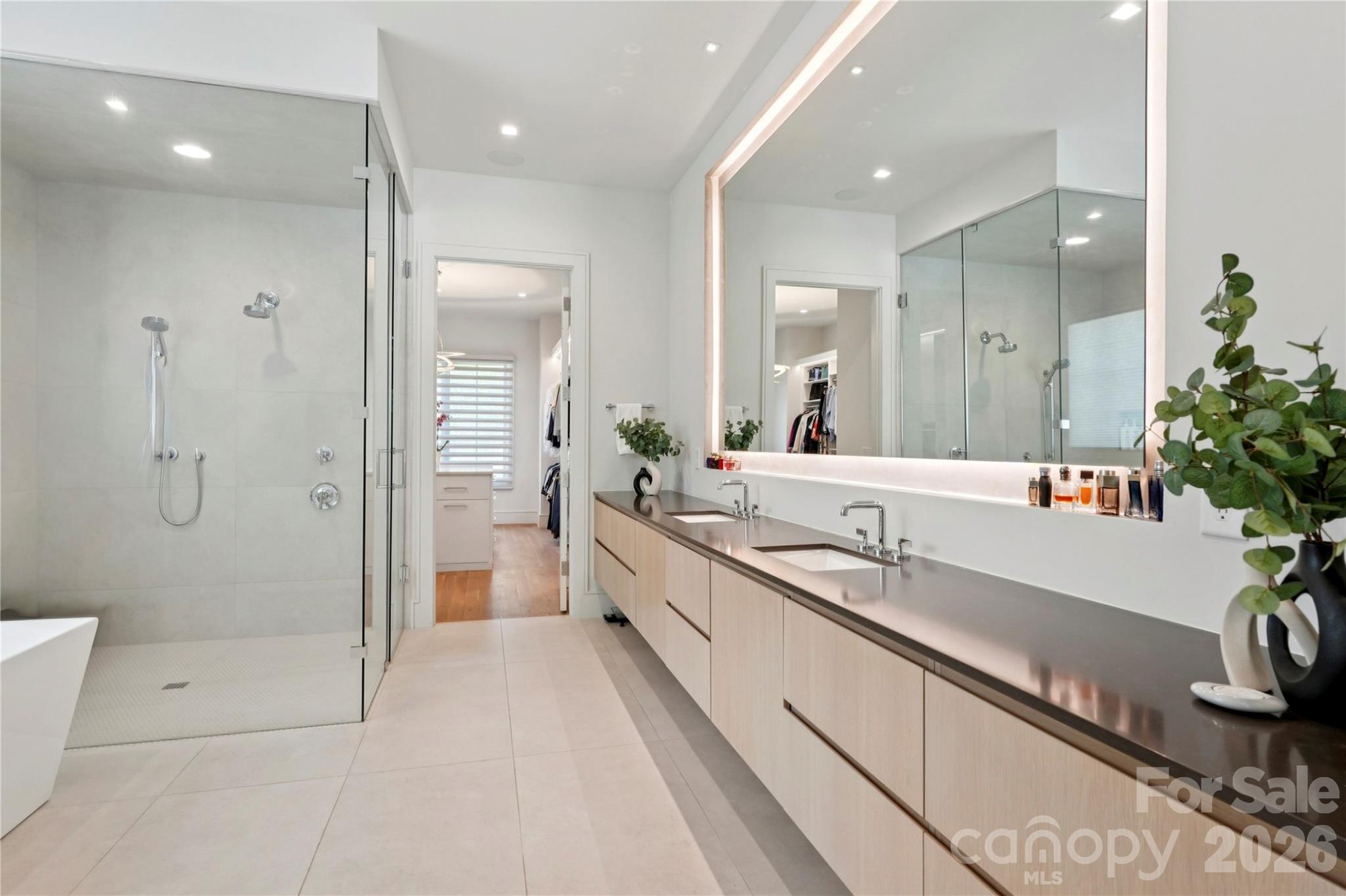 2103 Cortelyou Road Charlotte, NC 28211 - Photo 19 of 45 a large white bathroom with a double vanity sink a large mirror and shower