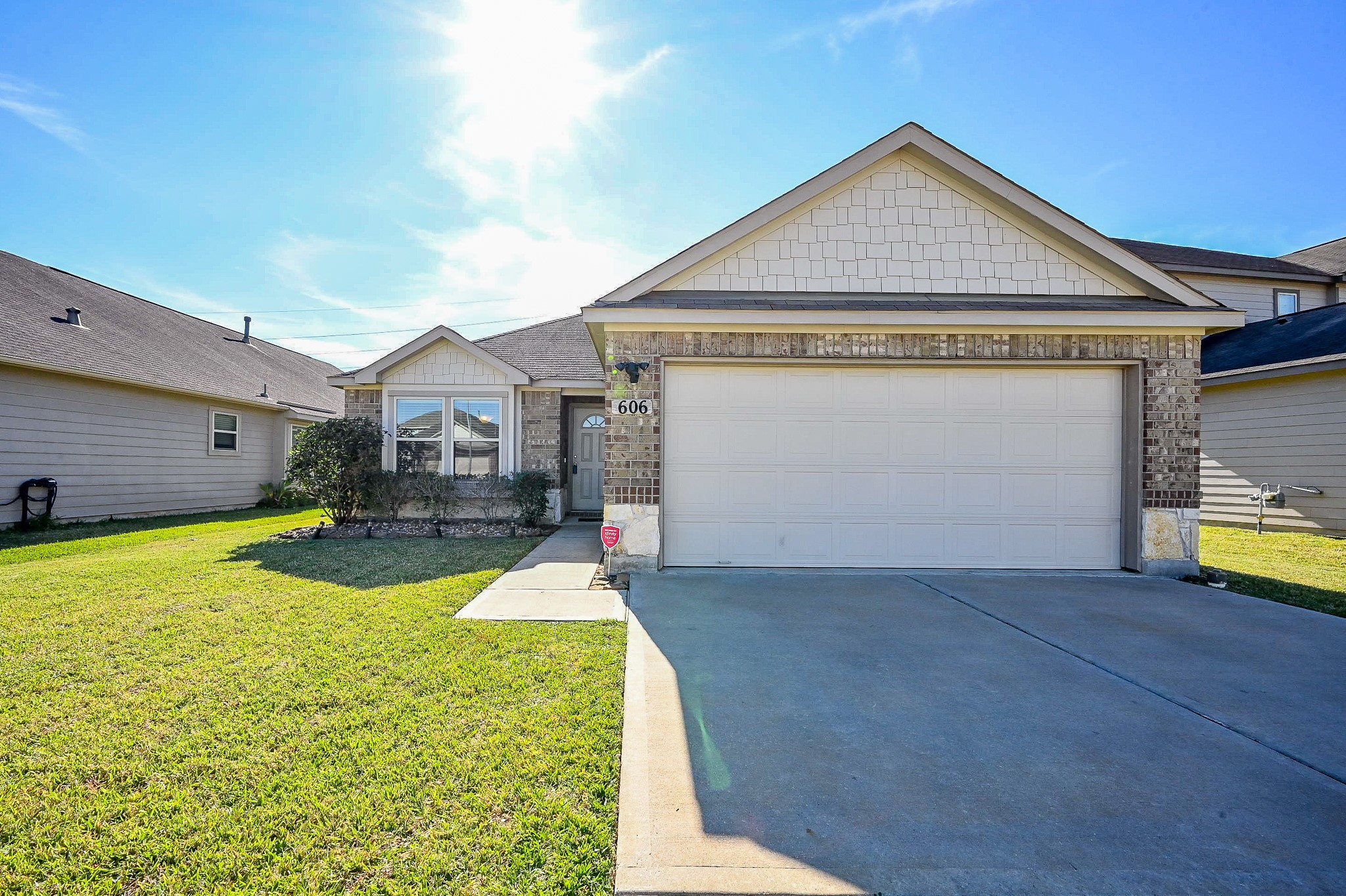 a view of a house with a yard and a garage