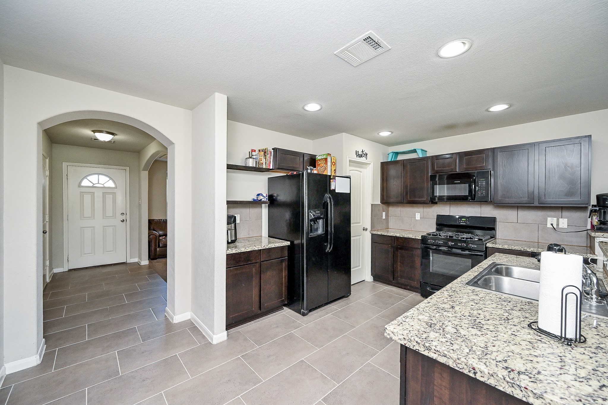 606 Palo ALto Court Rosharon, TX 77583 - Photo 6 of 23 a kitchen with stainless steel appliances granite countertop a refrigerator and a stove top oven