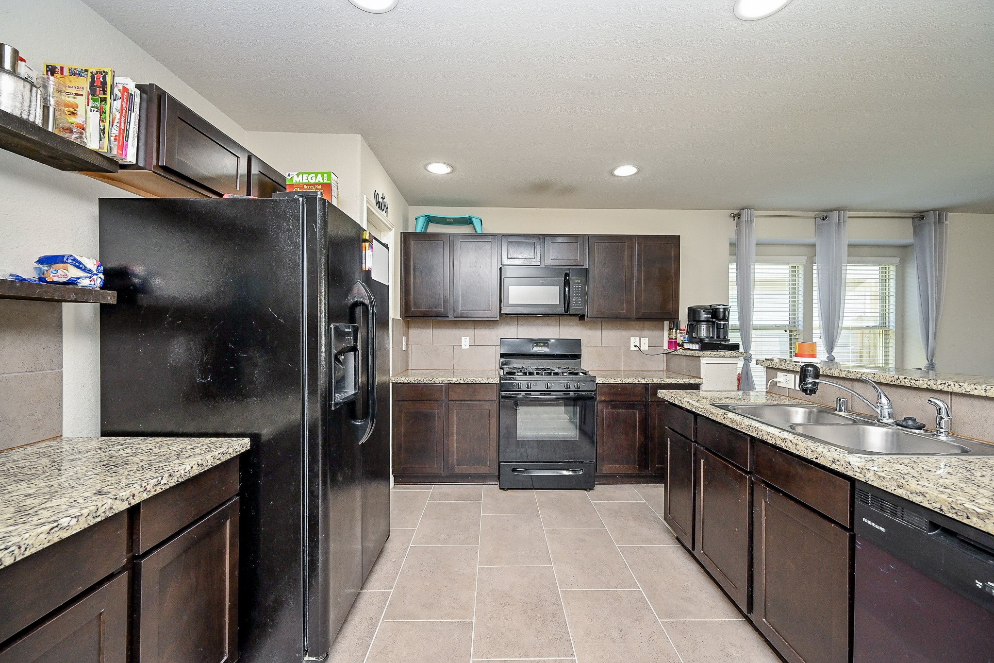 606 Palo ALto Court Rosharon, TX 77583 - Photo 7 of 23 a kitchen with stainless steel appliances granite countertop a refrigerator and a sink