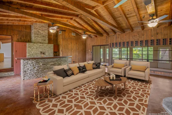 a living room with furniture and a floor to ceiling window