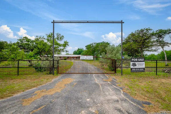 a view of a chair and table on the side of the road