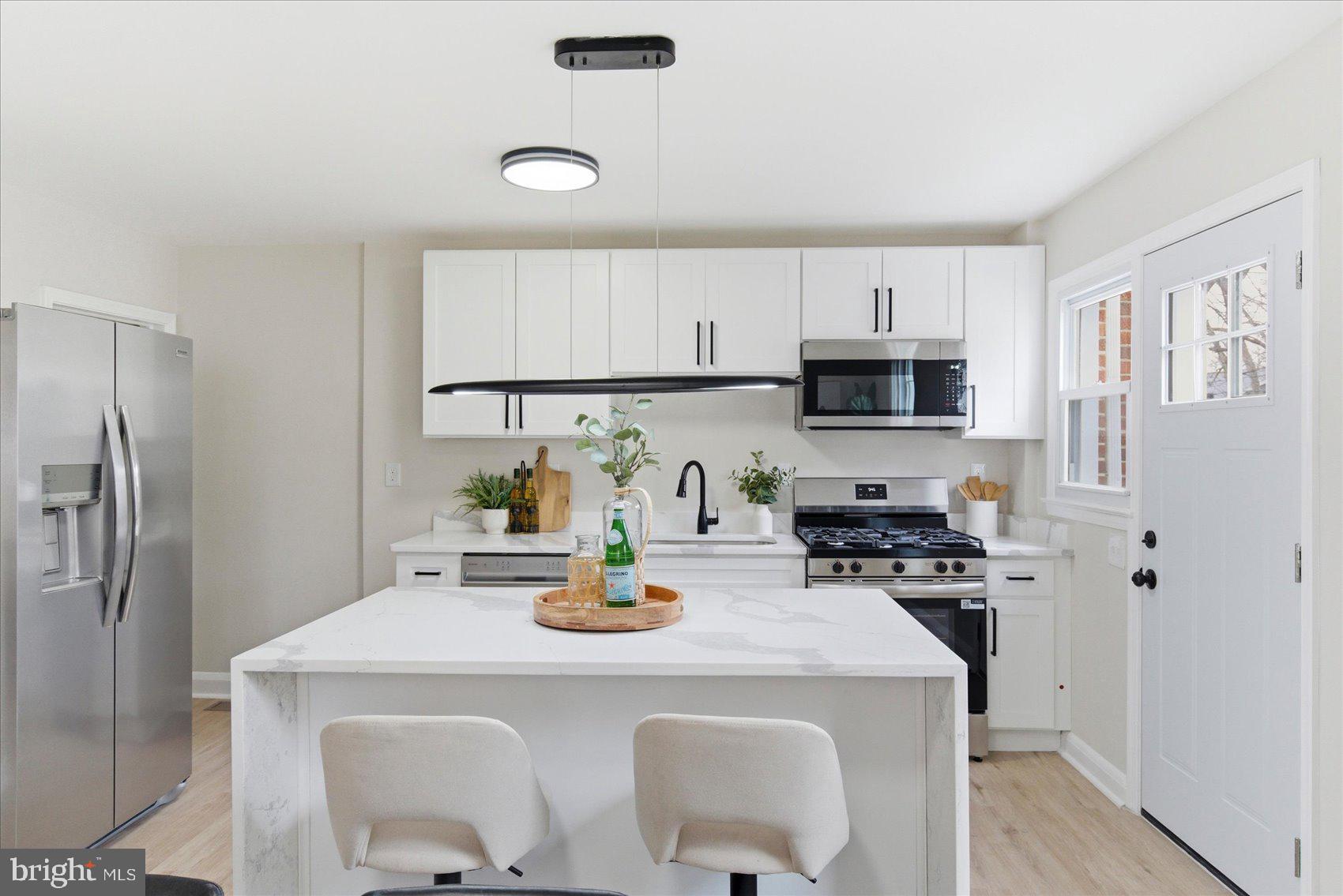 10 Mardrew Road Baltimore, MD 21229 - Photo 11 of 37 a kitchen with a sink a stove and refrigerator