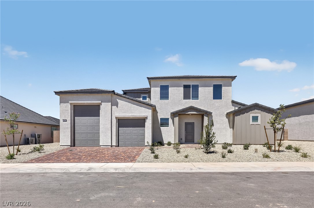 347 Sam Way Mesquite, NV 89027 - Photo 1 of 32 A contemporary desert-style residence featuring multiple garages and a neatly landscaped front with drought-tolerant plantings.