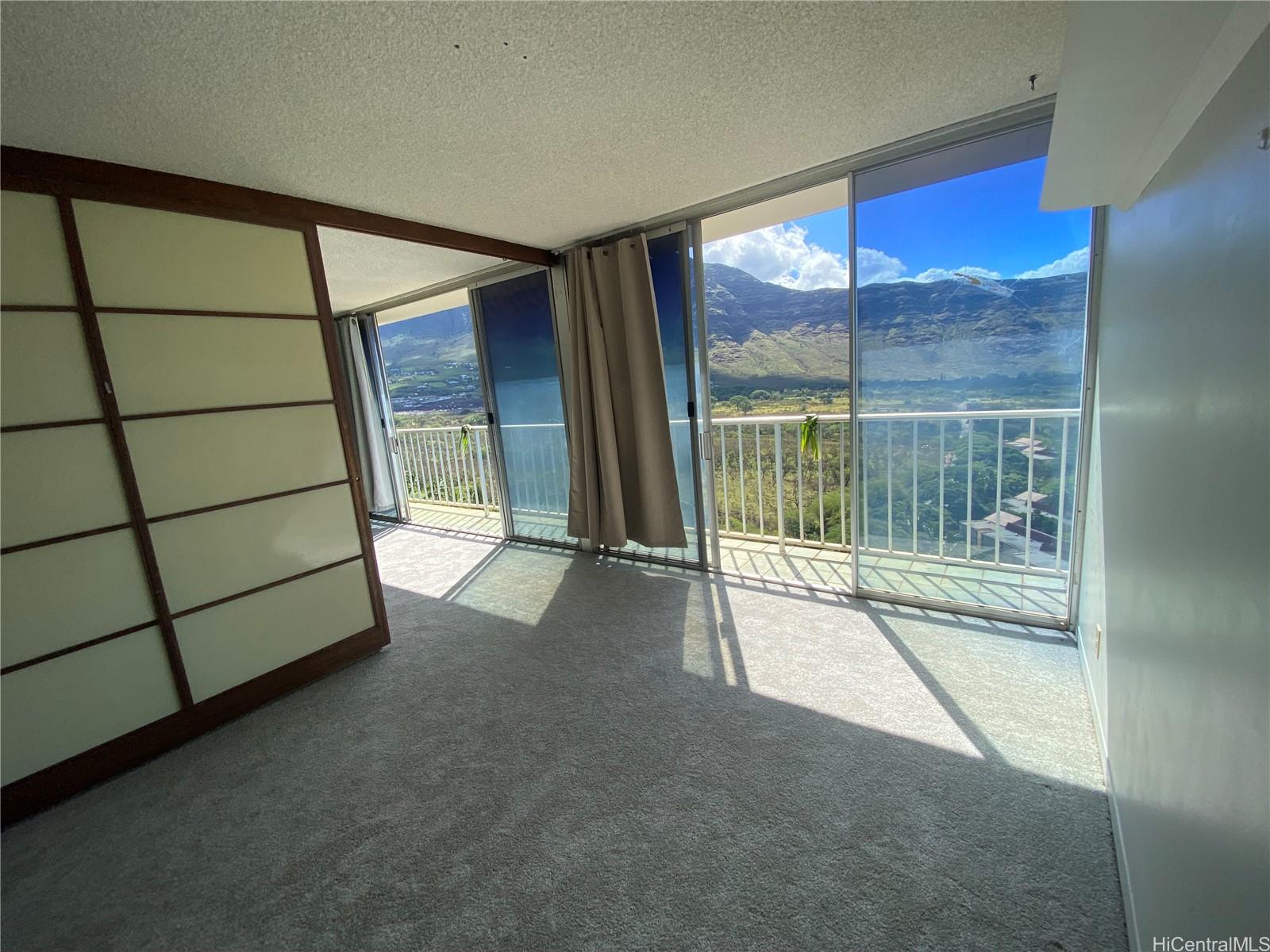 84-710 Kili Drive, Unit 1815 Waianae, HI 96792 - Photo 3 of 7 a view of an empty room with a sliding door