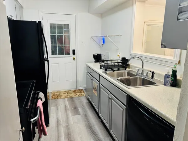 a kitchen with a sink a stove and cabinets