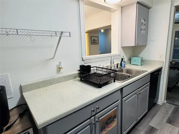 a metallic refrigerator freezer sitting in a kitchen