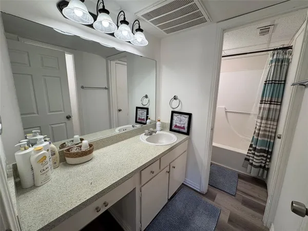 a bathroom view of a toilet and a mirror