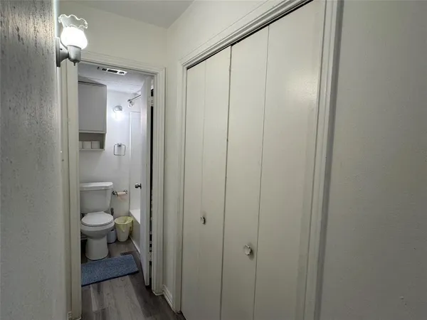 a bedroom with a bed window and a chair