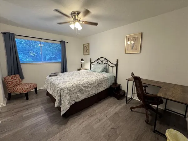 a large bed sitting in a bedroom next to a window