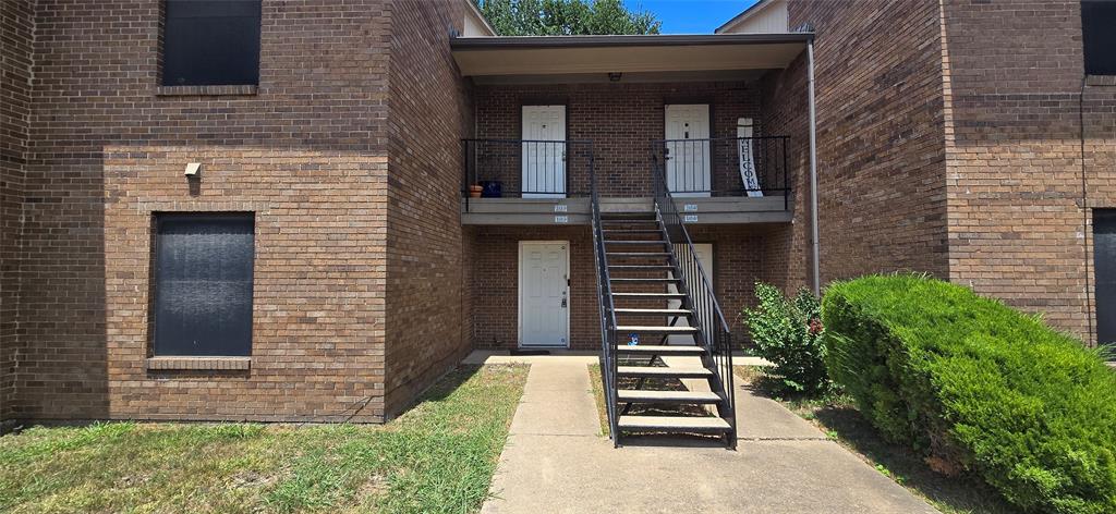4484 Chaha Road, Unit 103 Garland, TX 75043 - Photo 13 of 13 a view of a brick house with plants and wooden fence