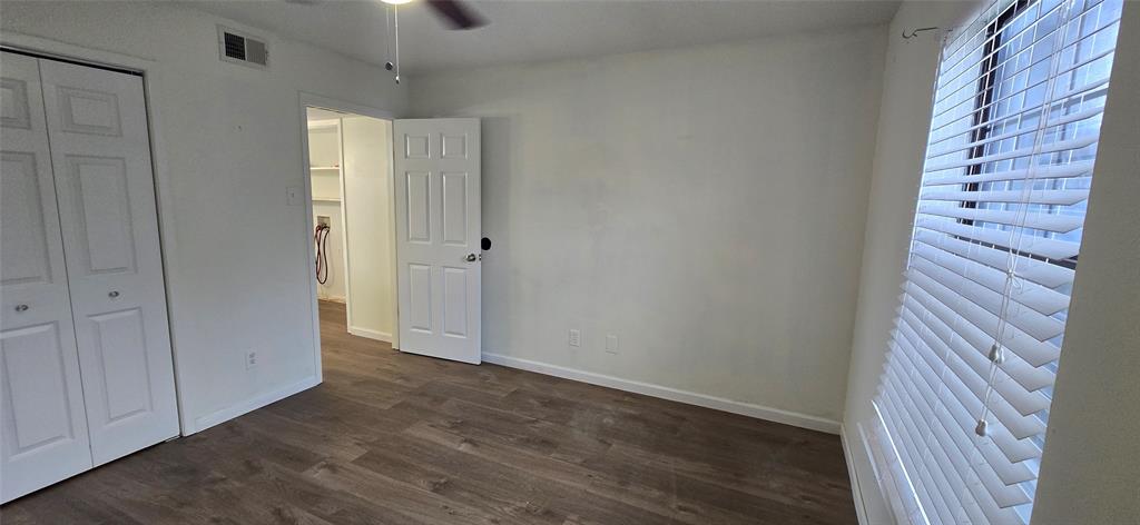 4484 Chaha Road, Unit 103 Garland, TX 75043 - Photo 7 of 13 a view of an empty room with closet and wooden floor