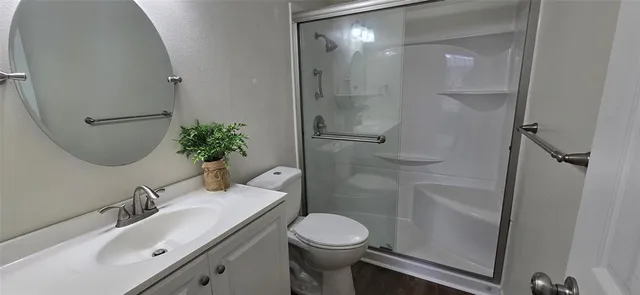 a bathroom with a sink toilet and shower